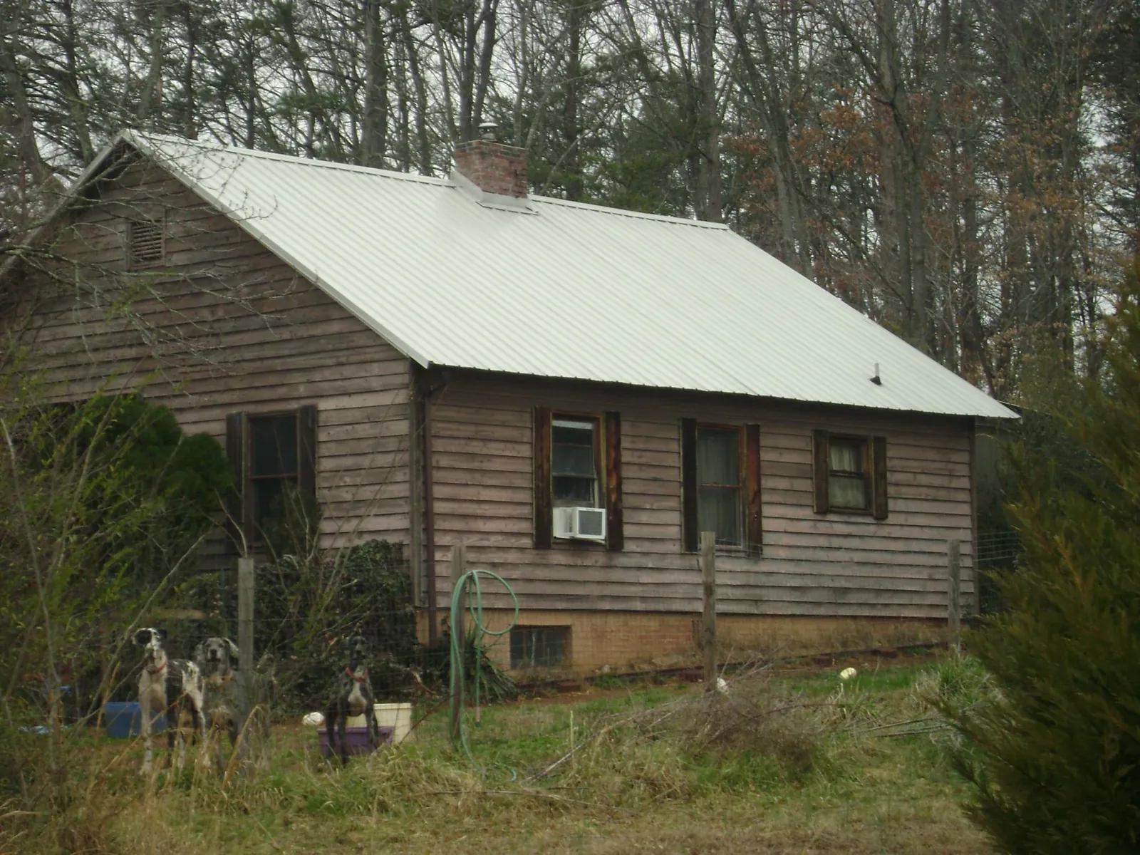 White metal roof on an old wood sided farmhouse, from a Metal Roof Installation job in Hazlehurst